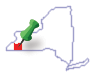 New York State outline showing Cattaraugus County in red with tack